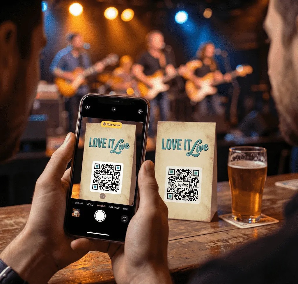 A fan scanning a Tiplor QR tip sign at a live band performance